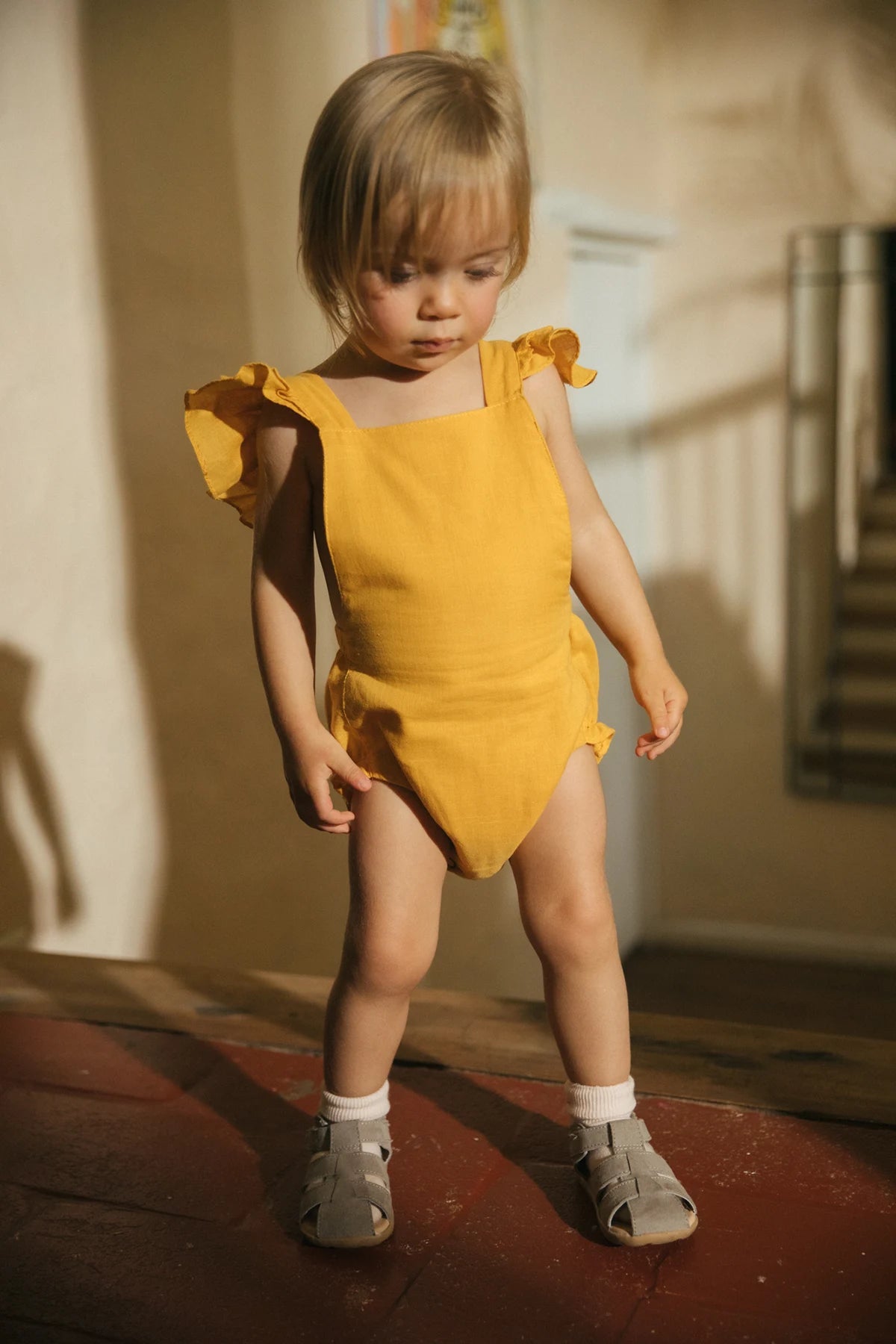 Jardinera Ada en lino mostaza para bebé niña de La Tutu