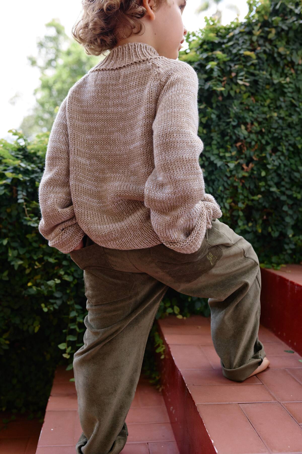 Niño usando Pantalón Noah Verde Oliva en pana combinado con saco tejido de La Tutu.